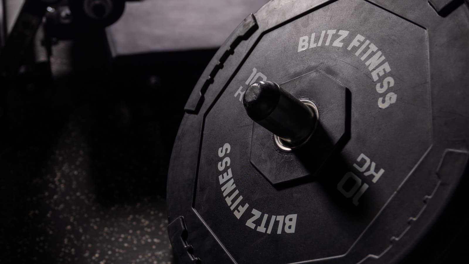 Dumbbells racked along the studio wall
