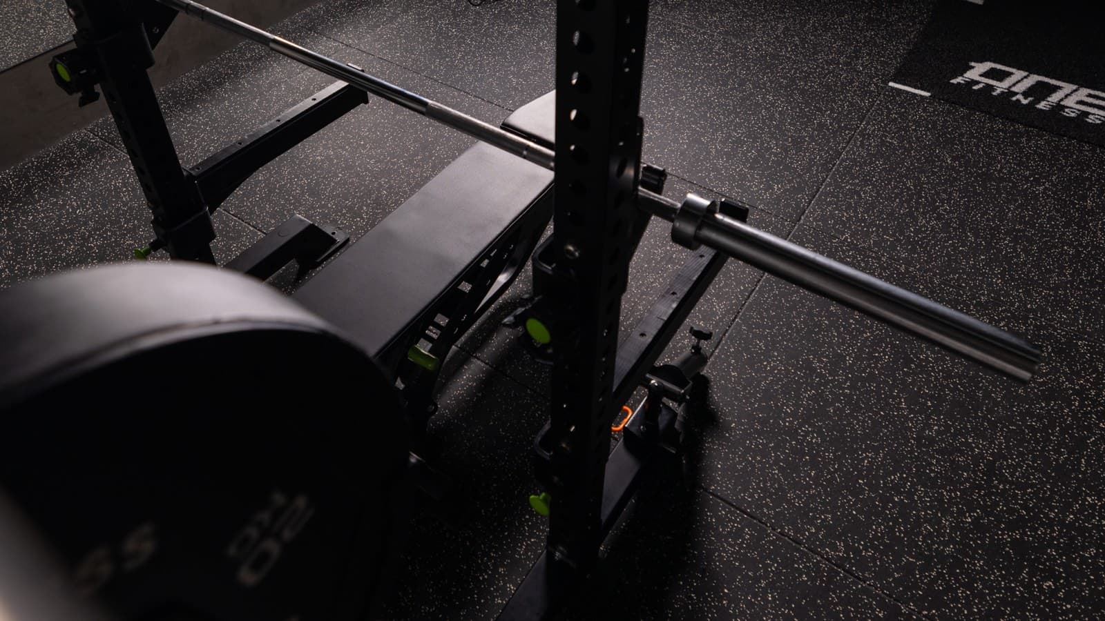 A loaded barbell resting in the squat rack